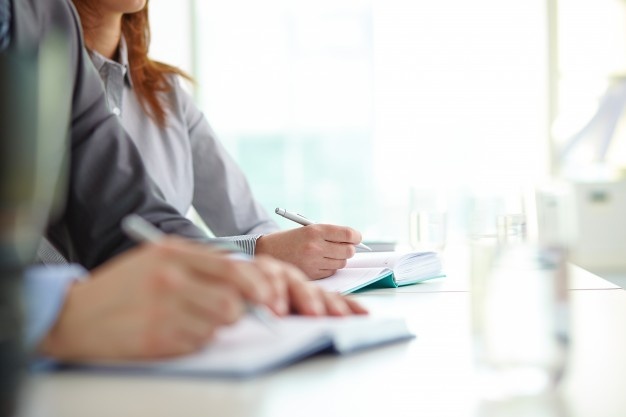 hands-close-up-of-co-workers-writing_1098-2513